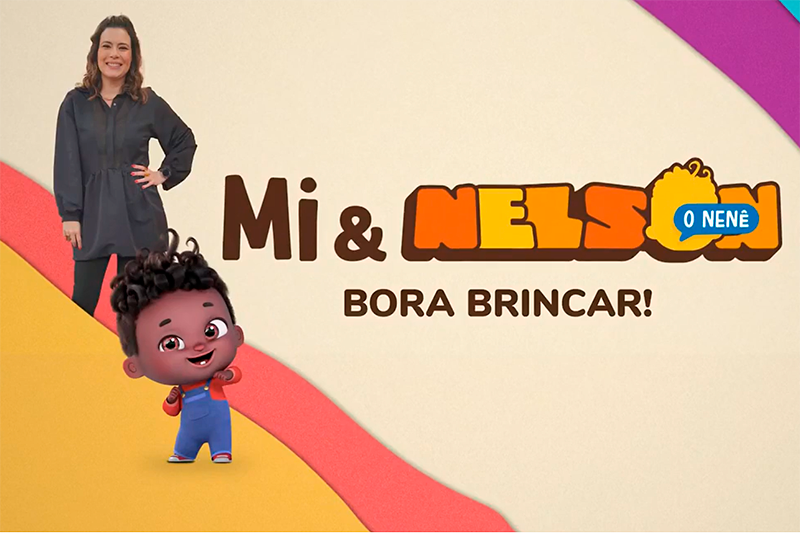 Montagem com a repórter Michele Loreto e o personagem Nelson Neto, o nenê. Michele é uma mulher branca de cabelos na altura do ombro, ela sorri e está com a mão na cintura. Nelson Neto é um personagem bebê em 3D, negro, que usa macacão azul e sorri. A imagem possui o texto "Mi & Nelson o nenê, bora brincar!" e ilustra o texto "Nelson Neto, o Nenê, ganha quadro na Globo".